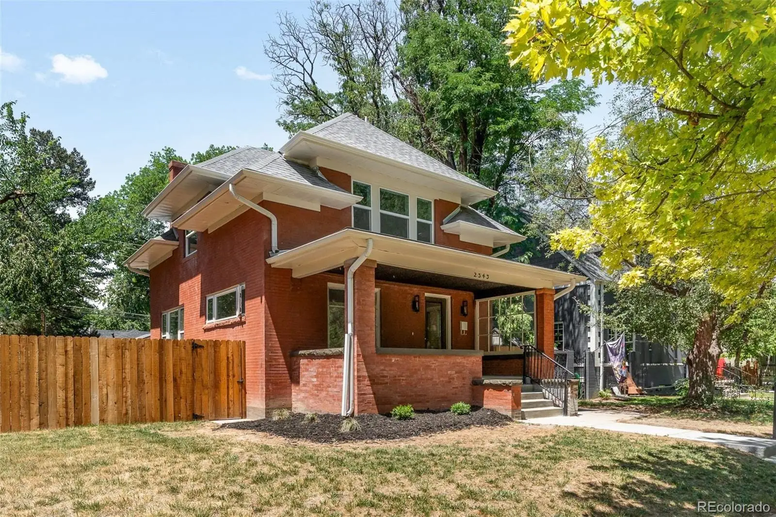 A front view of a house with a yard at 2343 Dahlia Street